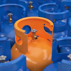 Orange gas cylinder close-up among blue cylinders, 3d render